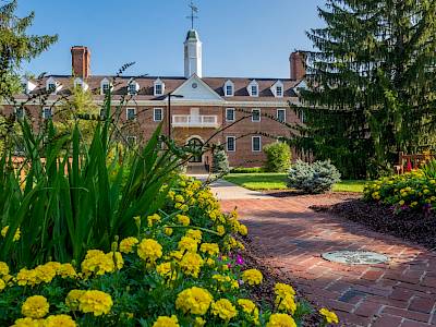 A brick building with yellow flowers in front of it, located in Oxford, Ohio.