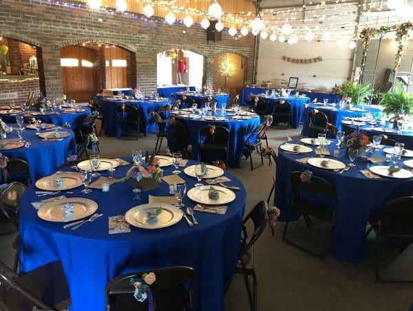 Wedding venue with blue tablecloth tables