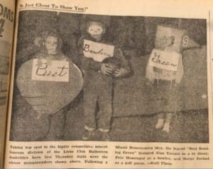 A newspaper with a picture of a group of people dressed up in costumes for Halloween in Oxford, OH.