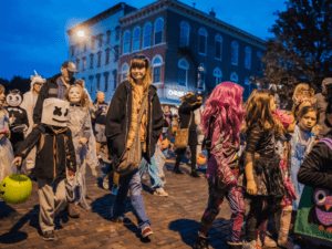 A group of people walking on the sidewalk.