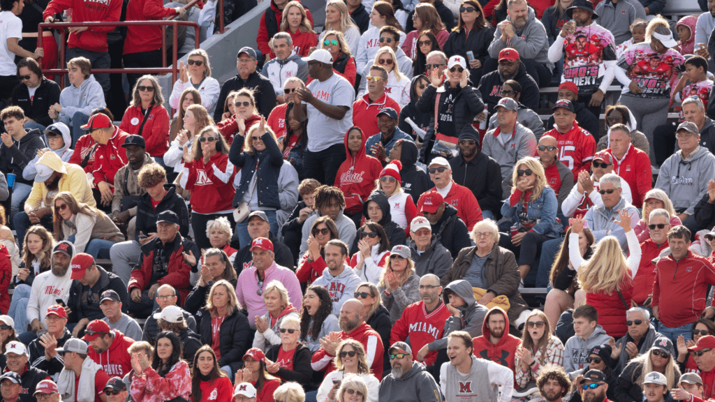 A crowd a fans celebrates during a Miami RedHawks football game at Yager stadium.