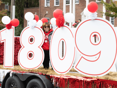 Homecoming parade with large cut out numbers reading "1809" in white with red outline