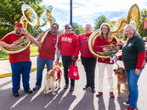 Miami University President Crawford and Dr. Crawford posing with band instruments