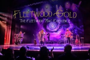 Photo of Fleetwood Gold band on stage under purple lighting