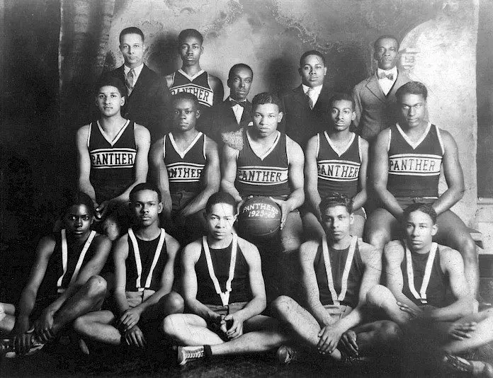 An old photo capturing an Oxford, OH basketball team from black history, unitedly posing for a picture.