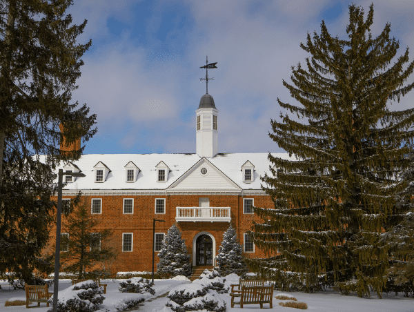 Red brick hotel exterior with a snowy roof