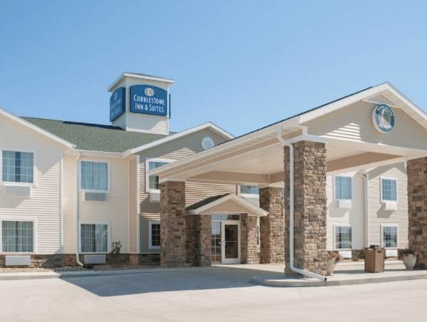 A large white building with a blue sign on top of it.