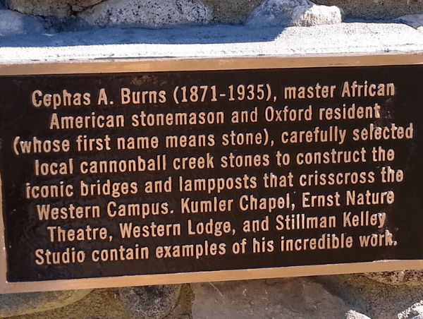 A plaque is shown on the side of a building.