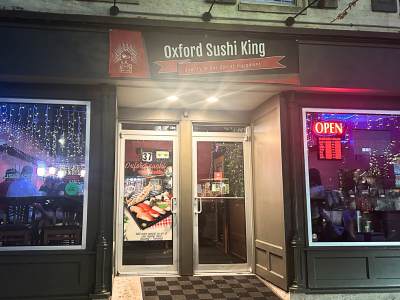 Exterior store front of Oxford Sushi King at night