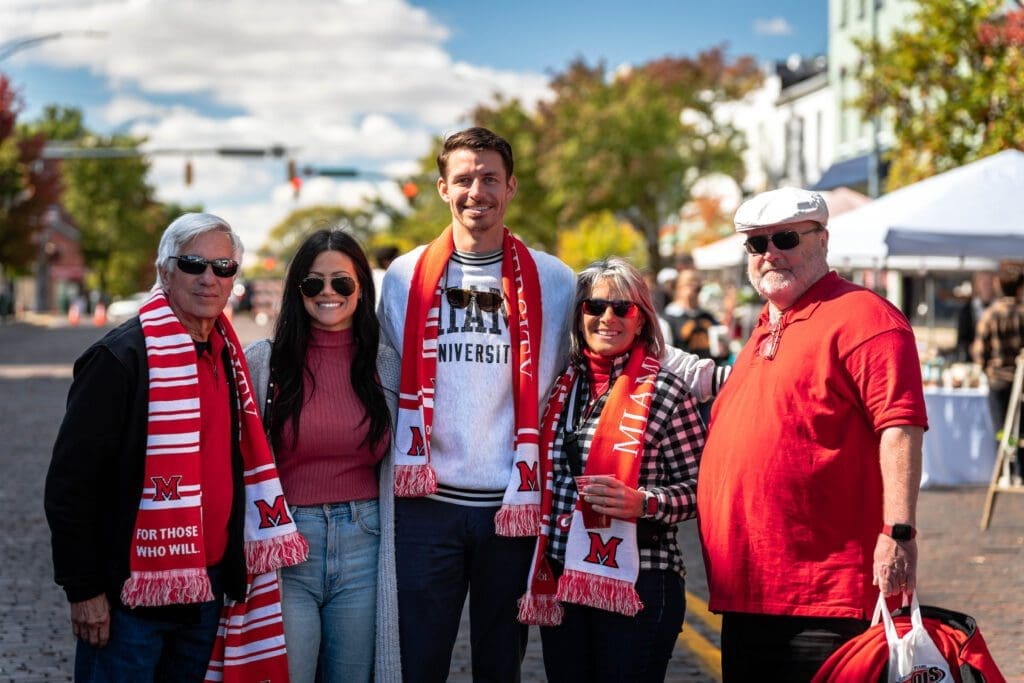 A family decked out in Miami gear enjoying High Street