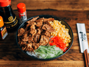 Ramen Hachi meal, a bowl of food on top of a wooden table.