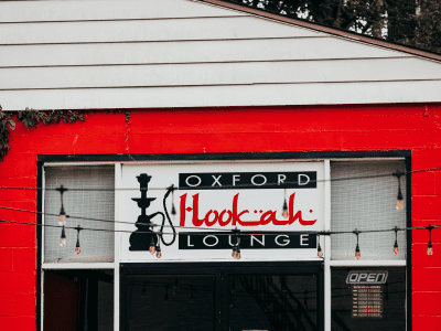 A sign for the hookah lounge outside of an establishment.