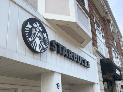 A starbucks sign on the side of a building.
