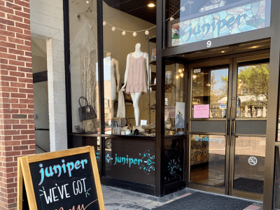 A store front with a sign that says " juniper we 've got it ".