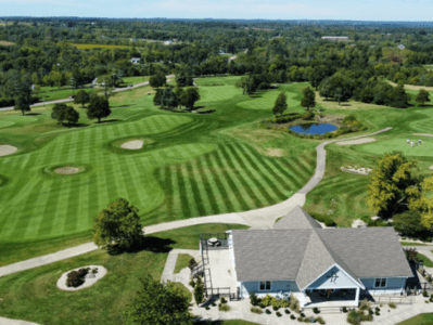 A golf course with many green areas and buildings.