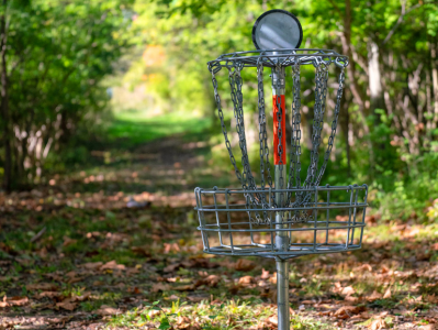 A metal basket with a disc golf hole in it.