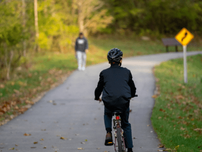 A person riding a bike on the side of a road.