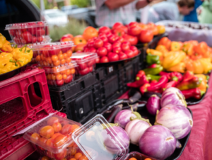 A table full of fresh produce at an outdoor market.