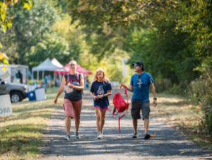 A group of people walking down the road