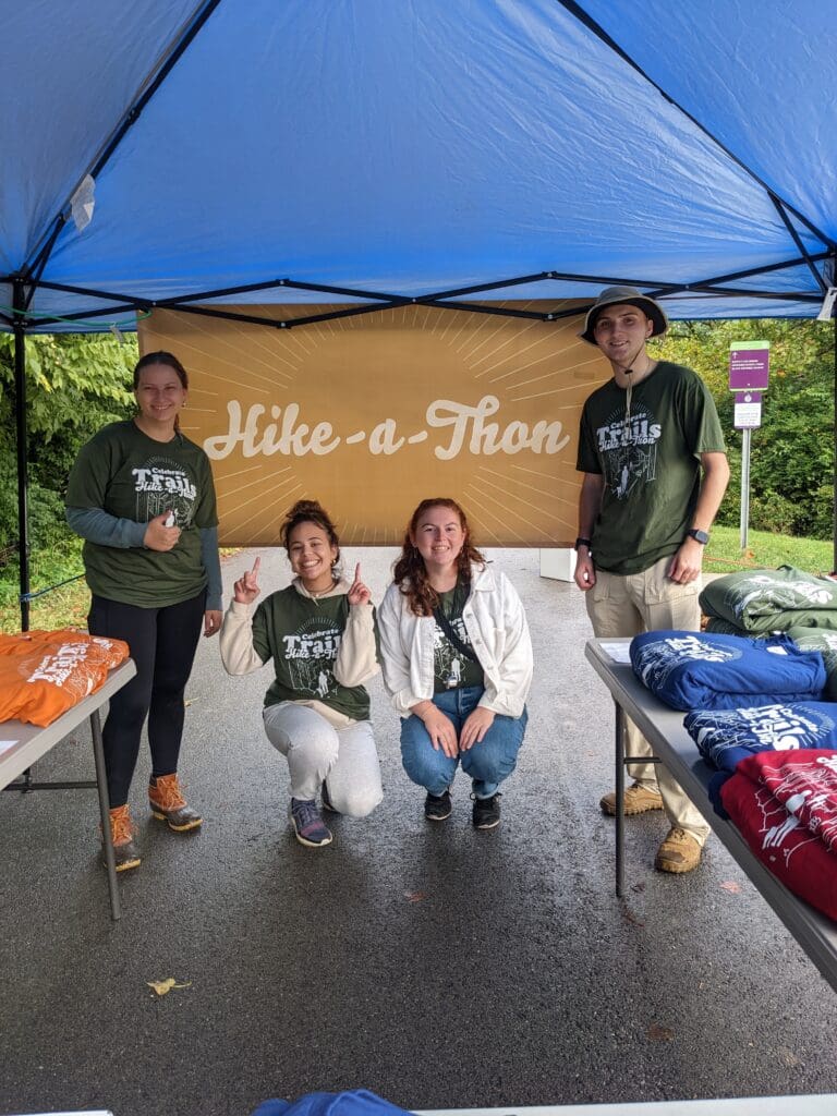 Four friends posing in a blue tent