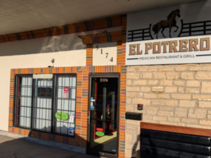 Exterior of El Potrero restaurant with beige brick siding