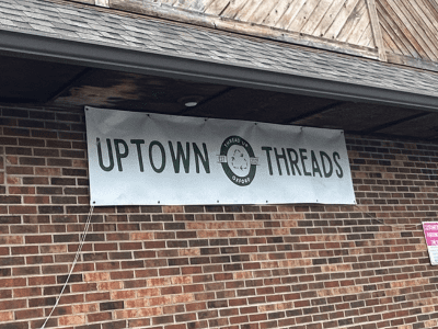Exterior brown brick building of Uptown Threads