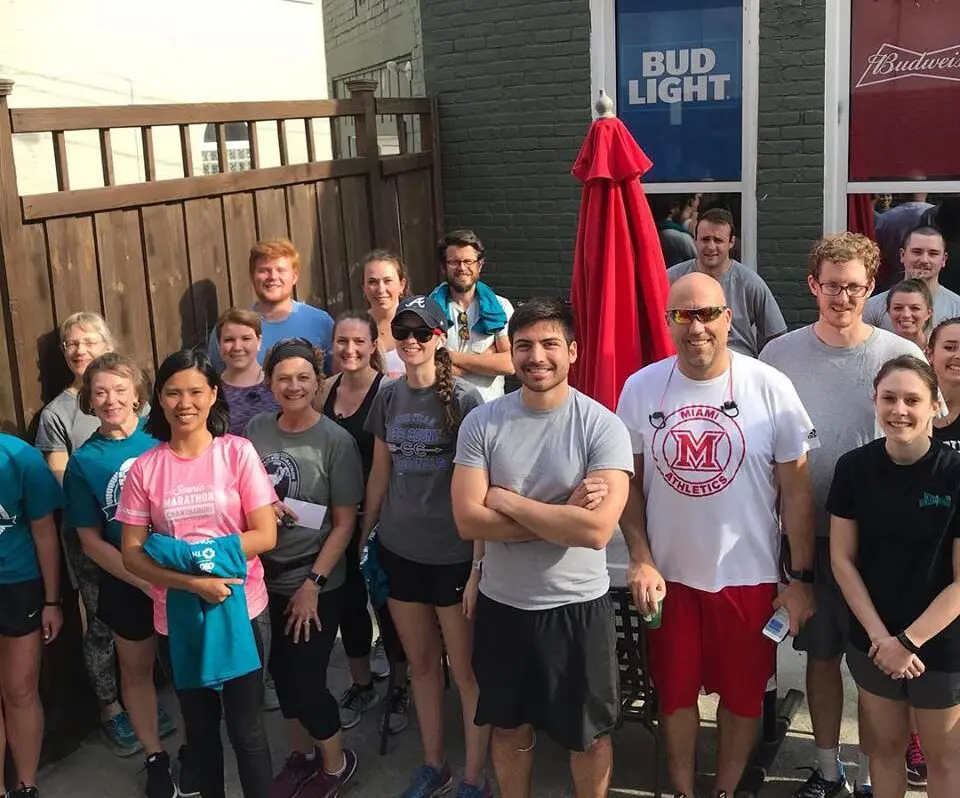 A group of people posing for a photo outside a pub in Oxford, Ohio, possibly after participating in one of the local pub runs.