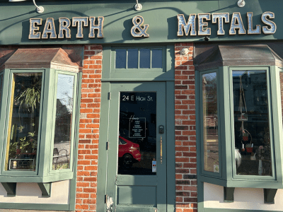 Exterior of Earth & Metals shop with red brick and green door