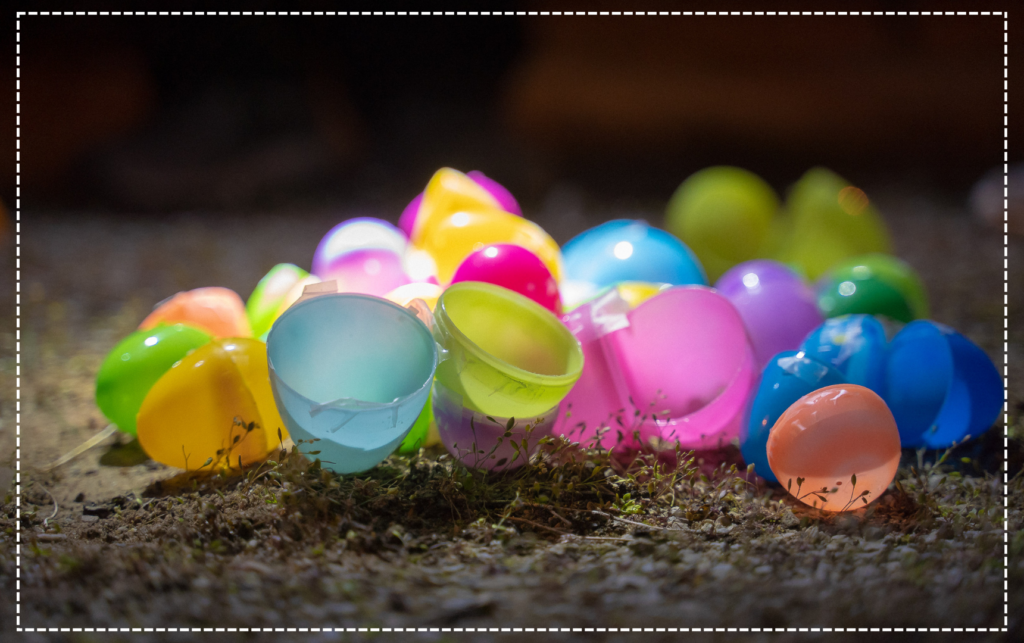 Colorful plastic Easter eggs on ground.