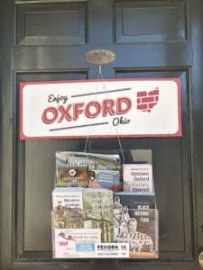 Close up view of Enjoy Oxford's door with informational leaflets