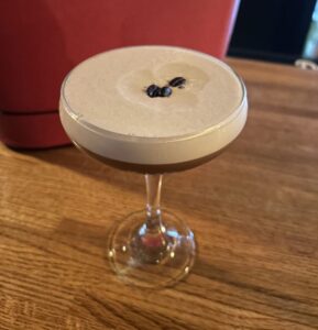 Espresso Martini garnished with three coffee beans at the bar