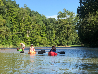 Three people on the river in kayaks from Morgan's Outdoor Adventures