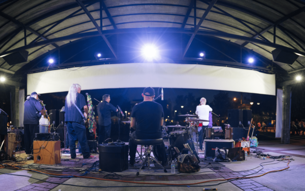 Band performing on stage at night.