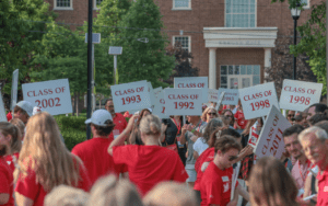 Miami University alumni gathered with class signs