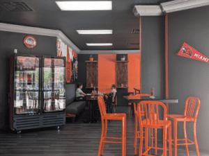 Interior of Cocina Latina with high top table and low top tables.