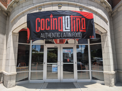 Exterior building of Cocina Latina with banner outside that reads "Cocina Latina Authentic Latin Food"