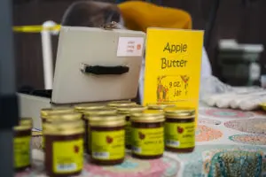 Jars of apple butter for sale on a picnic table