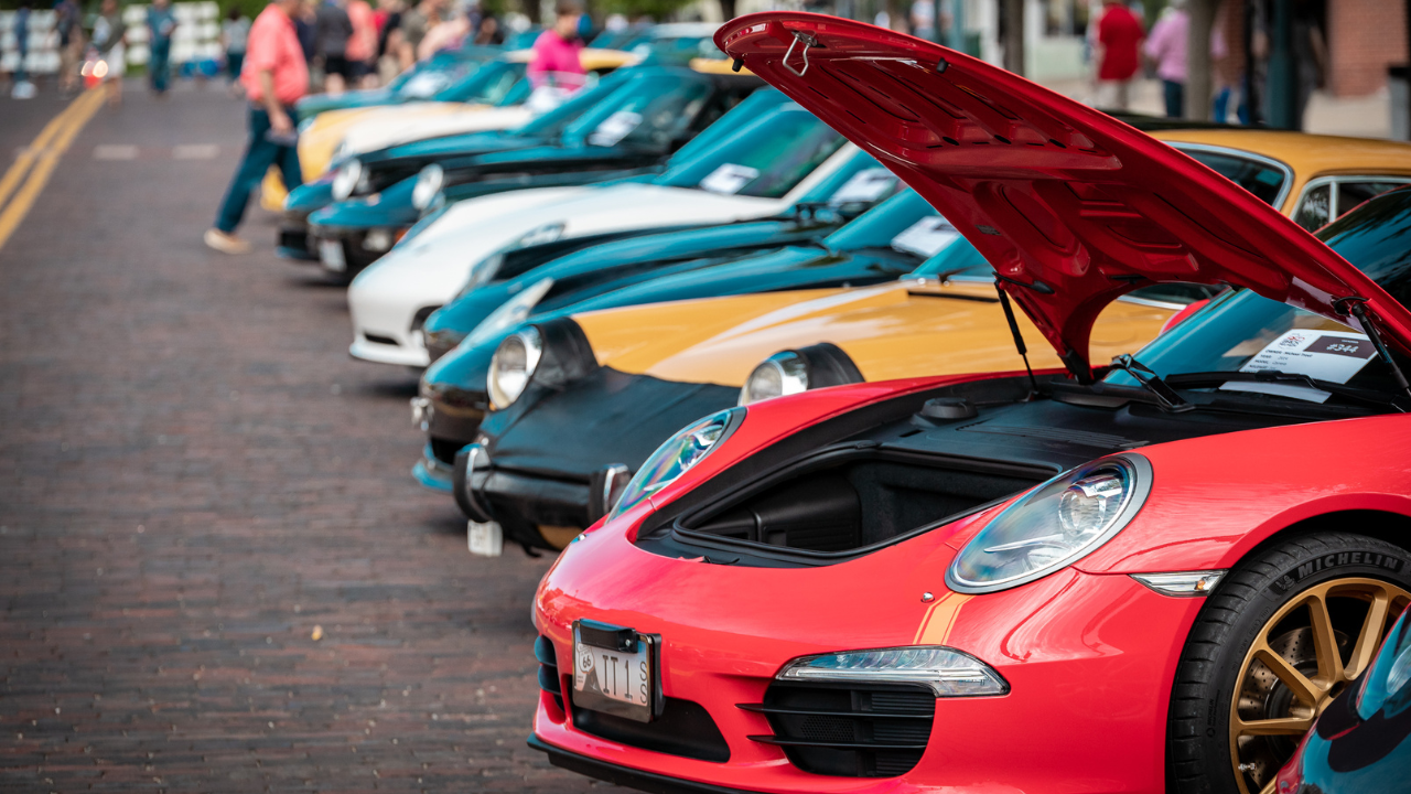 A line of Porsche cars parked on the  bricks of High Street in Uptown, Oxford, OH