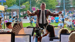 Conductor leading the Butler Philharmonic Orchestra on the Uptown Stage