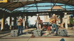 John Kogge performing on the Uptown stage with his band