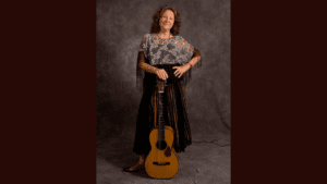 Lisa Biales posing with a guitar