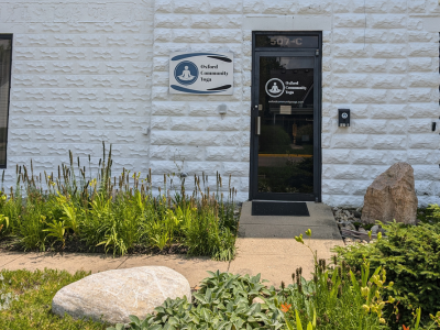 white brick exterior building with Oxford Community Yoga sign