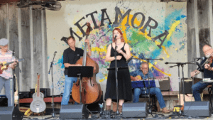Oxford Folk Jazz performing in front of "Metamora" sign