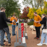 A group of young adults playing giant connect four