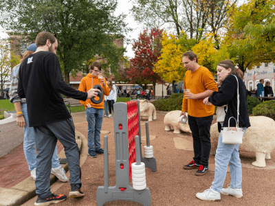 A group of young adults playing giant connect four
