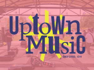 Uptown Music logo over top a band at the pavilion.