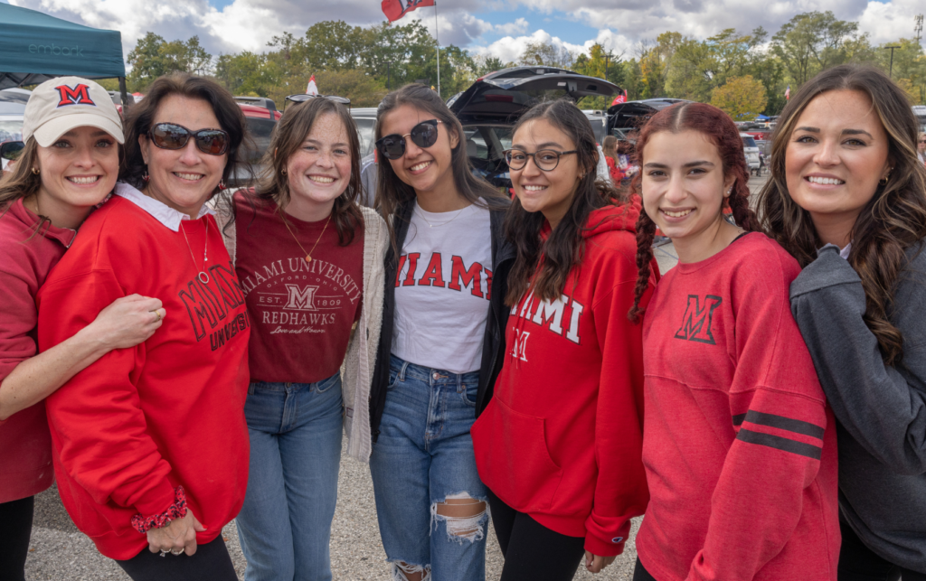 photo of seven women posing for Family Weekend Tailgate party