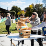 A family playing a game of giant Jenga as the bricks begin to fall at Oxford Memorial Park