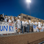 Crowd cheering at a football game.
