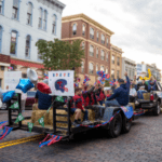 Parade float with people and balloons